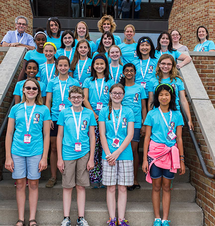 Past YWSI class standing at the entrance of OSC.