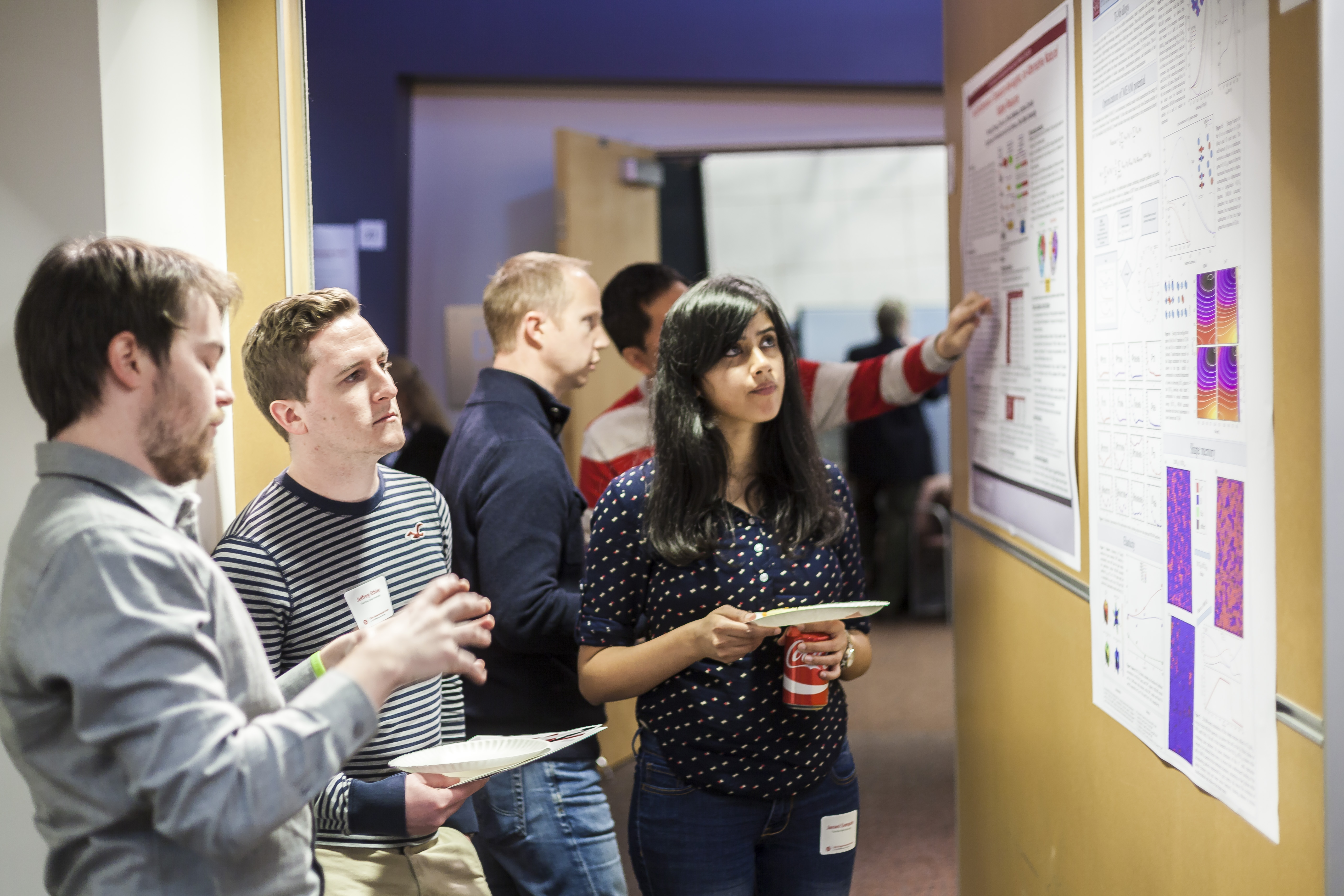 Attendees to the Dec. 3 SUG meeting discuss research during the Poster competition.